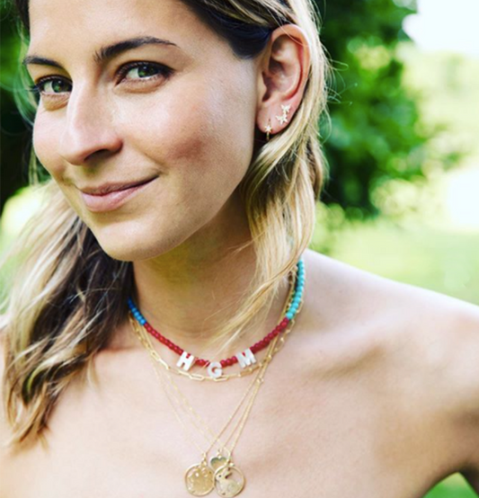 Sylvana Ward Durrett of Maisonette wearing Aurelia Demark Medium Lion and Medium Bunny gold pendants